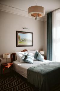a bedroom with a large bed with blue pillows at Hotel Senacki in Krakow +55 photos
