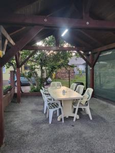 a table and chairs sitting under a pavilion at Apartman Martina in Gospić