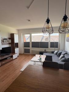 a living room with a couch and a table at Ferienwohnung Fortuna in Borkum
