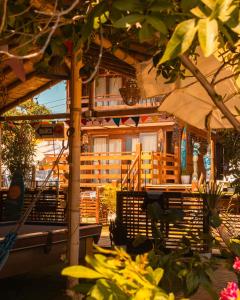 a wooden building with a table and an umbrella at Casa Lobos in Lobitos