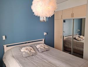a bedroom with blue walls and a bed with pillows at Seastar 101 in Kalajoki