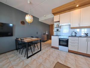 a kitchen with a table and a dining room at Seastar 101 in Kalajoki +14 photos