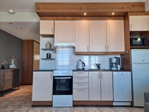 a kitchen with white appliances and white cabinets at Seastar 101 in Kalajoki