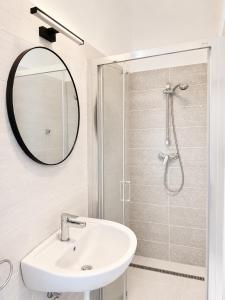 a bathroom with a sink and a shower at Small Garden Apartman in Sárvár +10 photos