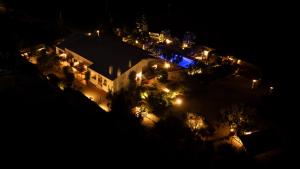 an aerial view of a building with lights at night at Quinta das Amendoeiras B&B in Nora