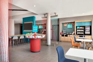 a restaurant with tables and chairs and a counter at avid hotel Austin - Tech Ridge by IHG in Austin