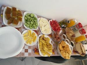 a table with plates of different types of food at Guesthouse Natyra Theth in Theth