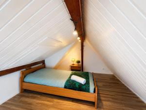 a bedroom with a bed in a attic at Villaloha - Appartement avec terrasse in Bray-Dunes