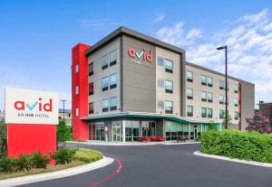 an office building with a sign in front of it at avid hotel Austin - Tech Ridge by IHG in Austin