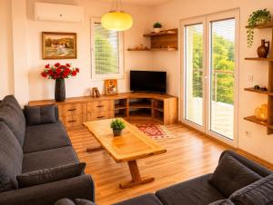 a living room with a couch and a table at Lake and Mountain Hideaway in Ohrid