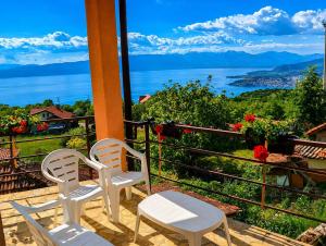 a balcony with two chairs and a view of the water at Lake and Mountain Hideaway in Ohrid