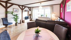 a living room with a couch and a table at Haus an der Pferdekoppel Nr 3 in Fehmarn