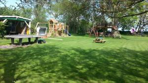 a park with a playground with a table and a ping at Haus an der Pferdekoppel Nr 3 in Fehmarn +5 photos