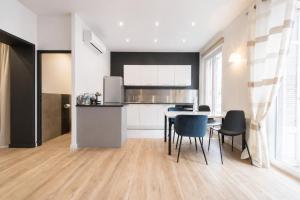 a kitchen and dining room with a table and chairs at F2 balcon à 1minute de la plage in Saint-Raphaël +4 photos