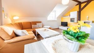 a living room with a couch and a table at Haus an der Pferdekoppel Nr 2 in Fehmarn