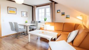 a living room with a couch and a table at Haus an der Pferdekoppel Nr 2 in Fehmarn