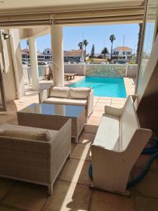 a view of a swimming pool from the balcony of a house at Russells on the Port in Velddrif
