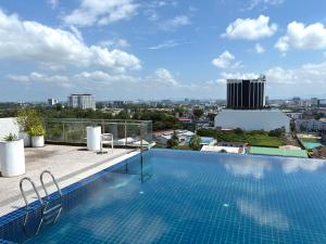 a swimming pool on the roof of a building at Kuching Kozi Square 2paxs Large Window CityView Infinity Pool 2E in Kuching