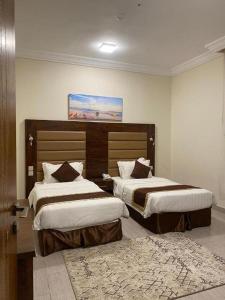 a hotel room with two beds and a rug at فندق فاتوران فرع ينبع in Yanbu +94 photos