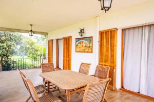 a dining room with a table and chairs on a porch at Majordoms Vila in Cornellá de Terri