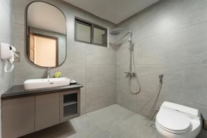 a bathroom with a toilet and a sink and a mirror at ORA Hotel in Văn La +35 photos