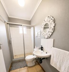 a bathroom with a shower and a toilet and a sink at Zhantique Guest House 2- Unit 12 in Boksburg