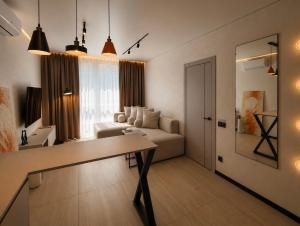 a living room with a couch and a table at Great Apart - Вид на Дніпро - 6 поверх - укриття на території ЖК in Kyiv