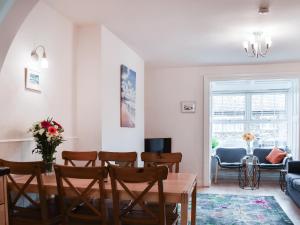 a living room with a table and chairs at Bithecutt Cottage in Bude