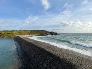 an aerial view of a rocky beach with the ocean at Bithecutt Cottage in Bude