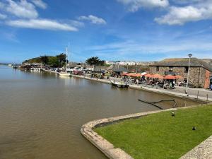 a body of water with boats in a harbor at Bithecutt Cottage in Bude