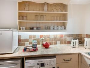 a kitchen with a counter top with a tea pot on it at The Old Sawmill One - Uk49336 in Plumpton Green