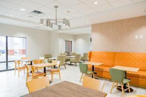 an empty waiting room with tables and chairs at Hampton Inn Inwood in Inwood