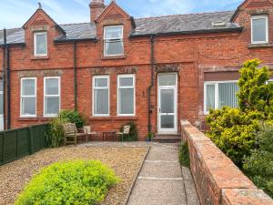 a brick house with a patio in front of it at The Haven in Annan