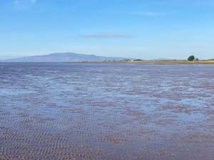 a large body of water with mountains in the background at The Haven in Annan