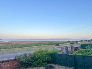 a view of the beach from the balcony of a house at The Haven in Annan +14 photos