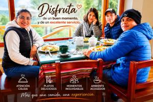 a group of people sitting at a table eating food at Urku Ñan Quilotoa in Sigchos