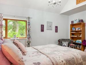 a bedroom with a bed and a window at Silk Hill Stables in Whaley Bridge