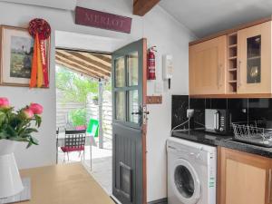 a kitchen with a washer and dryer at Silk Hill Stables in Whaley Bridge +9 photos