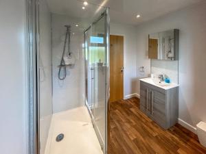 a bathroom with a shower and a sink at Fern Lodge - Uk51604 in Peel +4 photos