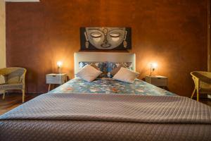 a bedroom with a bed with a mask on the wall at Quinta das Amendoeiras B&B in Nora +28 photos