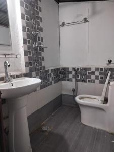 a bathroom with a sink and a toilet at Newari chulo ghar in Bhaktapur
