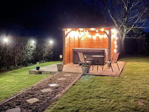 a table and chairs in a backyard at night at Herrock View in Evenjobb