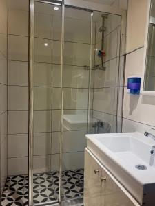 a bathroom with a glass shower and a sink at Nuo Taksim Rooms in Istanbul