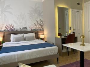 a bedroom with a bed and a desk and a table at Nuo Taksim Rooms in Istanbul
