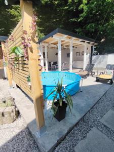 a house with a blue pool in the backyard at Kuća za odmor MERLIN HOUSE in Vrnjačka Banja