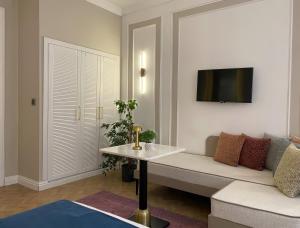 a living room with a couch and a tv on a wall at Nuo Taksim Rooms in Istanbul +7 photos
