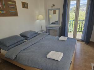 a bedroom with a bed with two towels on it at Myrtos Hidden Garden Villa in Ierapetra