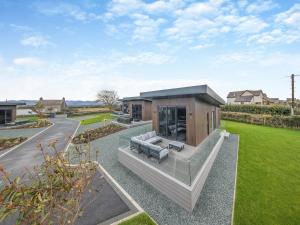 a house with a living room and a lawn at Lligwy Lodge 3 - Uk42793 in Llangefni