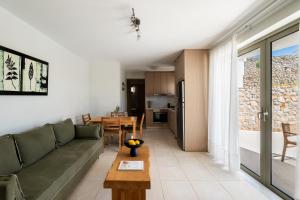 a living room with a couch and a table at Anassia Villas in Nafplio