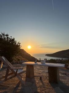 a picnic table on the beach with the sunset in the background at Sun Holiday Kea Private Pool Sea View in Pisses
